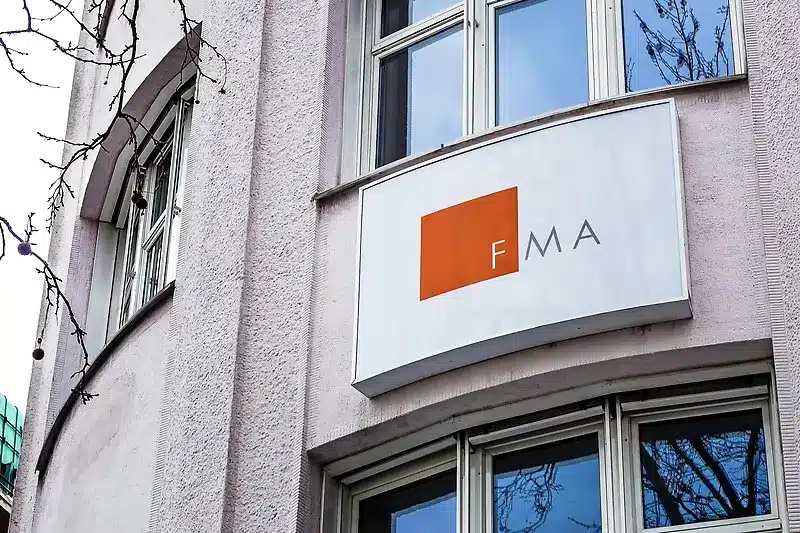 Close-up of the FMA Finanzmarktaufsicht sign on the exterior wall of a building in Vienna