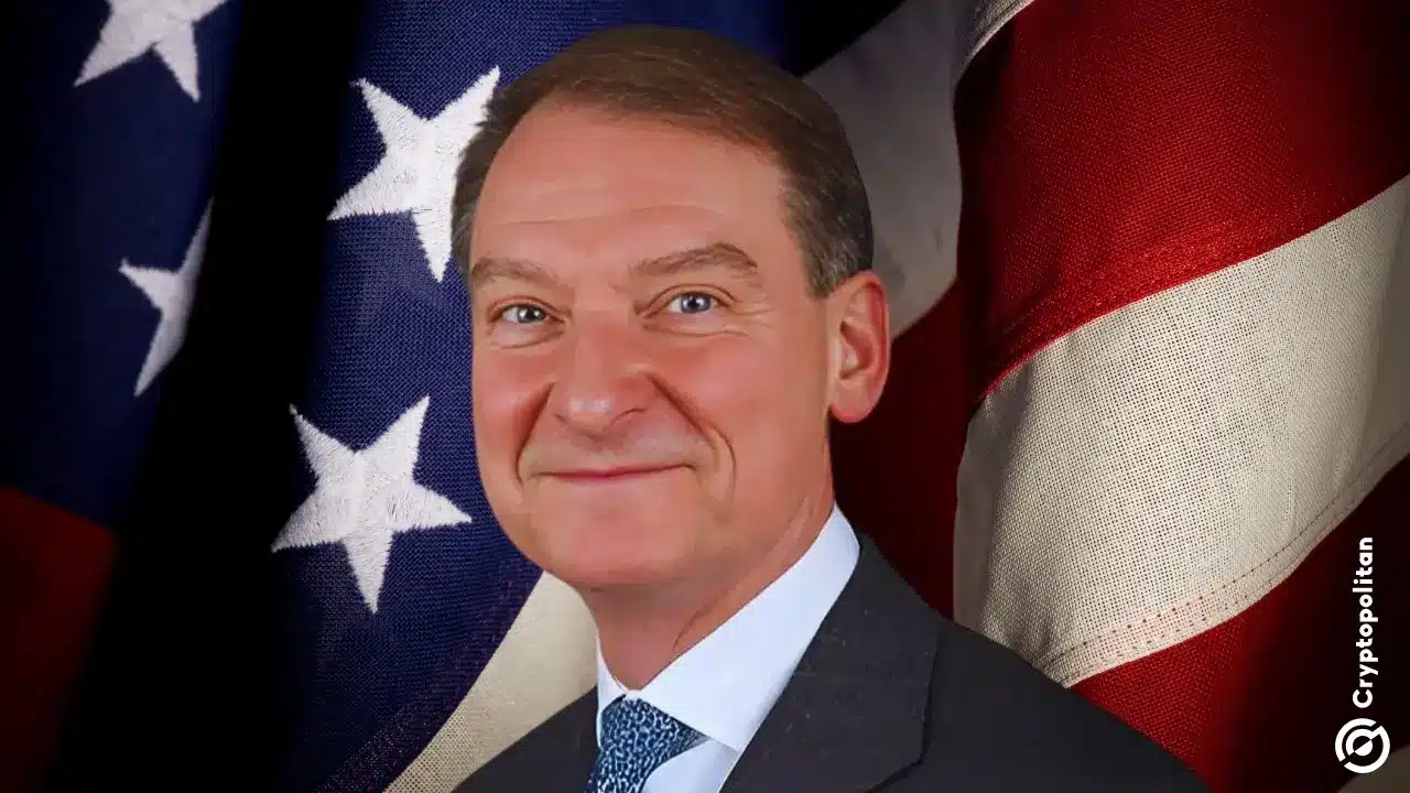 Portrait of Paul Atkins in a suit and tie, posed in front of United States flags.