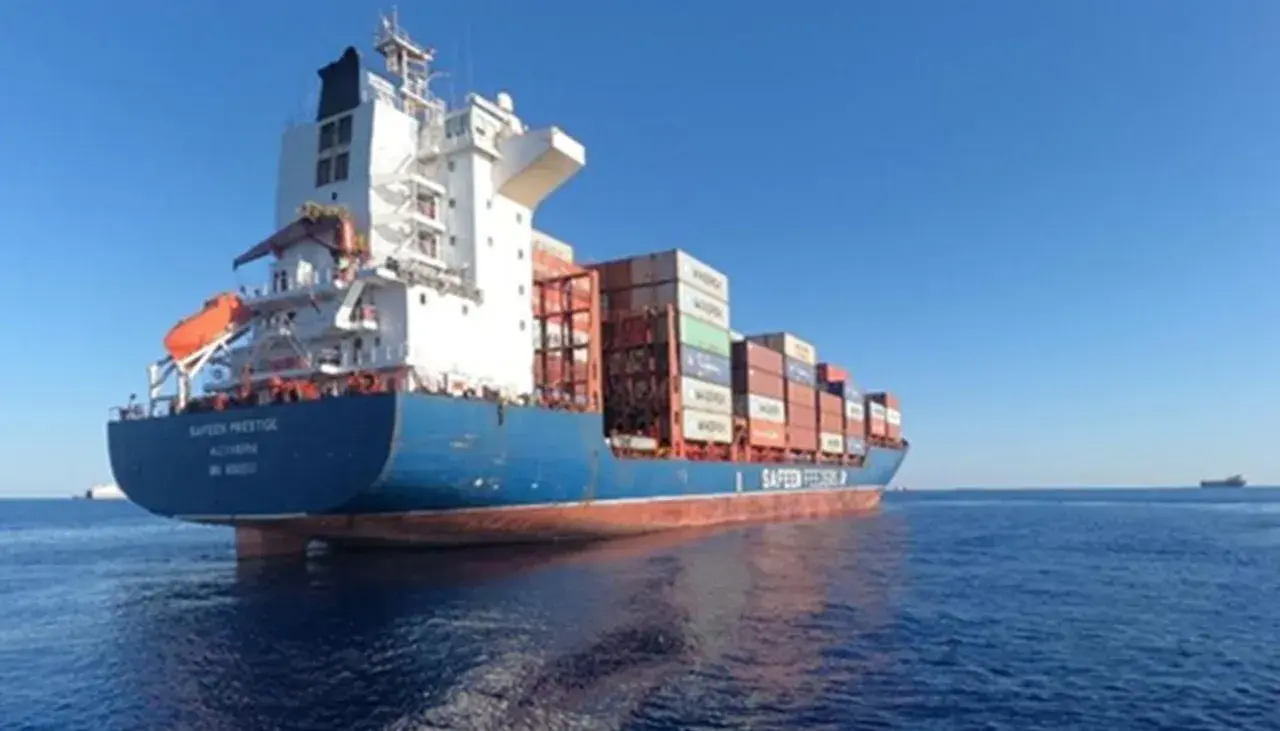Rear view of a Safreen Prestige container ship sailing on a calm blue ocean under a clear sky