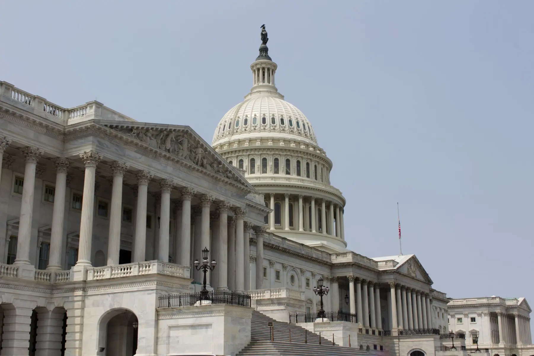 Close-up view of the white marble facade and dome of the US Capitol building in Washington DC